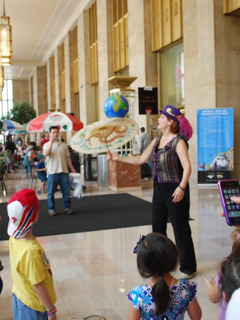 Children Gather on National Train Day to Watch Street Performer